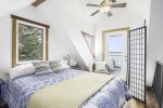 Lofted bedroom with a private balcony with bistro set
